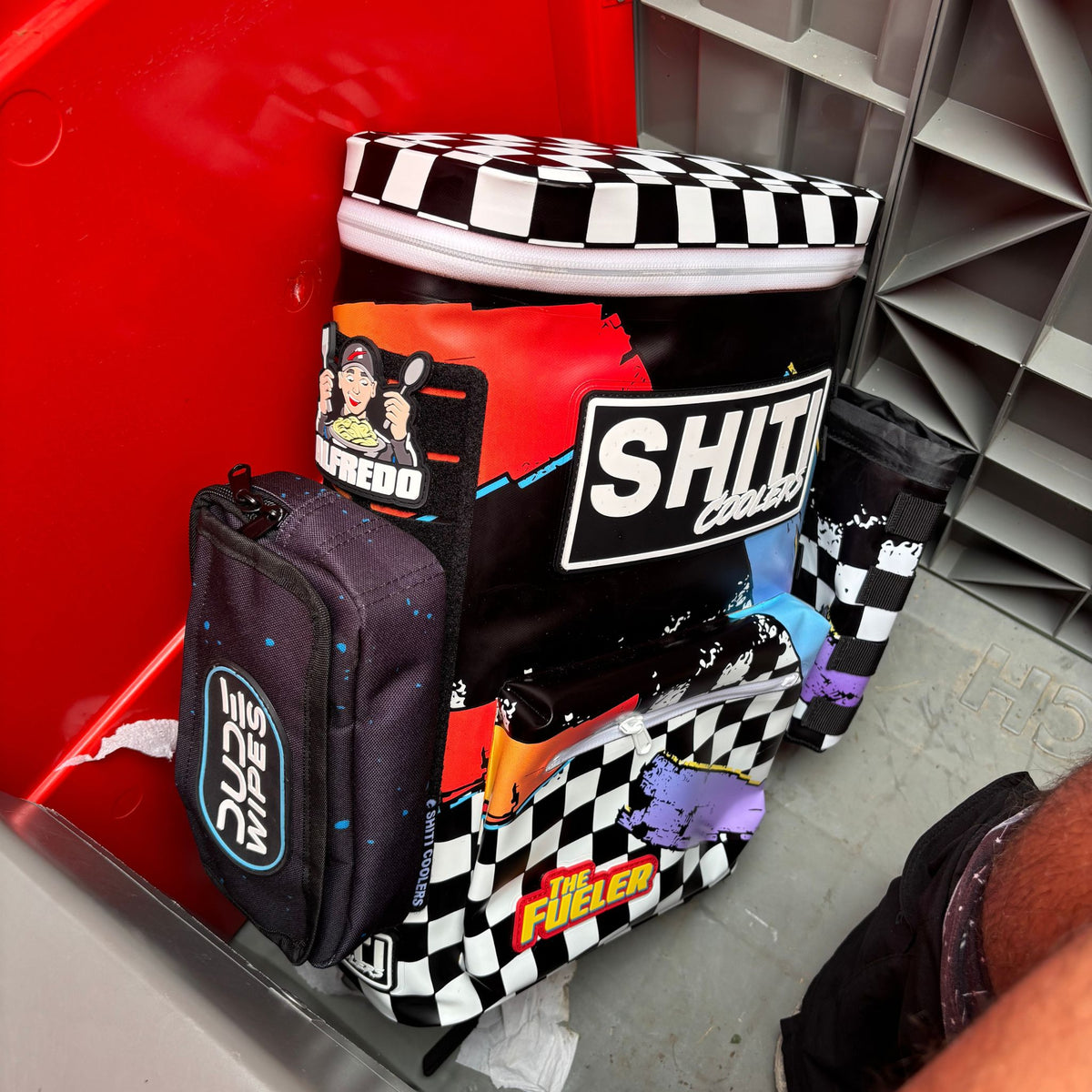 Customizable DUDE Wipe attachment and wipes attached to a SHITI cooler, perfect for party essentials and convenience.