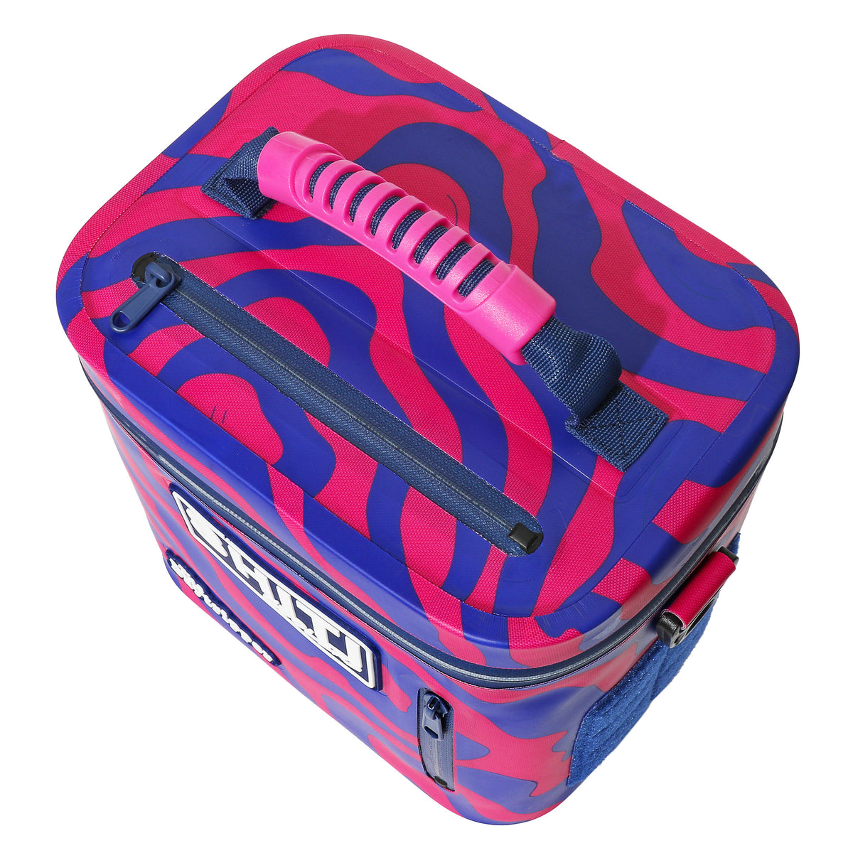 Vibrant pink and blue patterned soft cooler with a top handle, designed to hold six cans, featuring a zippered closure.
