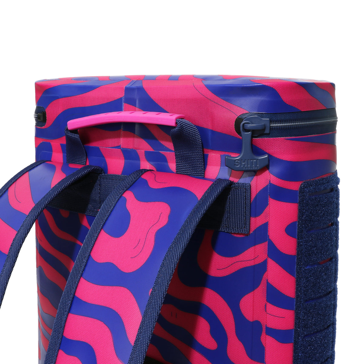 Vibrant pink and blue Daytripper Backpack Cooler with adjustable straps and a top handle for easy carrying.