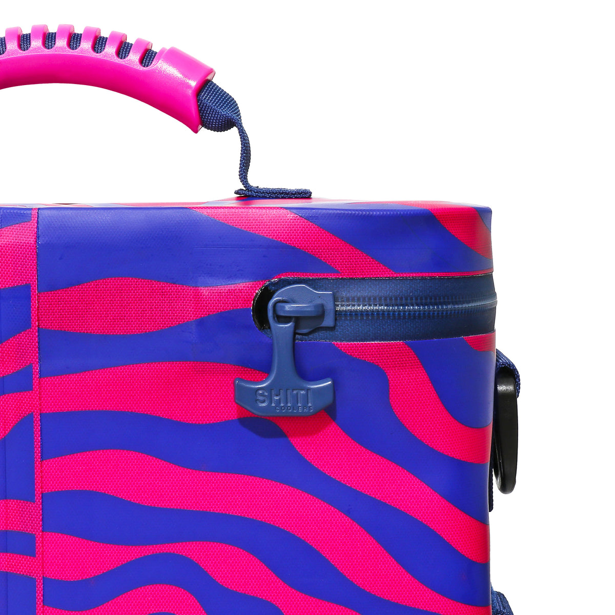 Vibrant Daytripper Soft Cooler in pink and blue with a sturdy handle and zipper, designed to hold 12 cans.