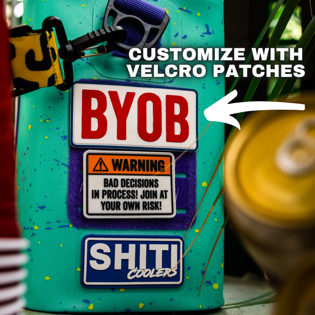 Brightly colored Panty Dropper Soft Cooler featuring customizable Velcro patches, including &quot;BYOB&quot; and playful warning signs.
