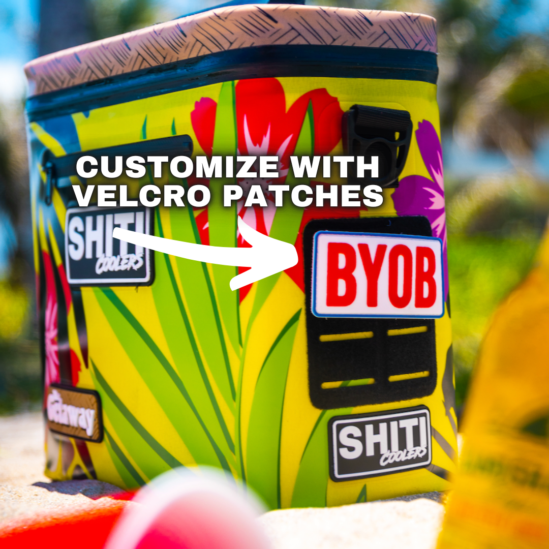Vibrant Getaway Soft Cooler with tropical design, featuring customizable Velcro patches for personalization. Holds 12 cans.
