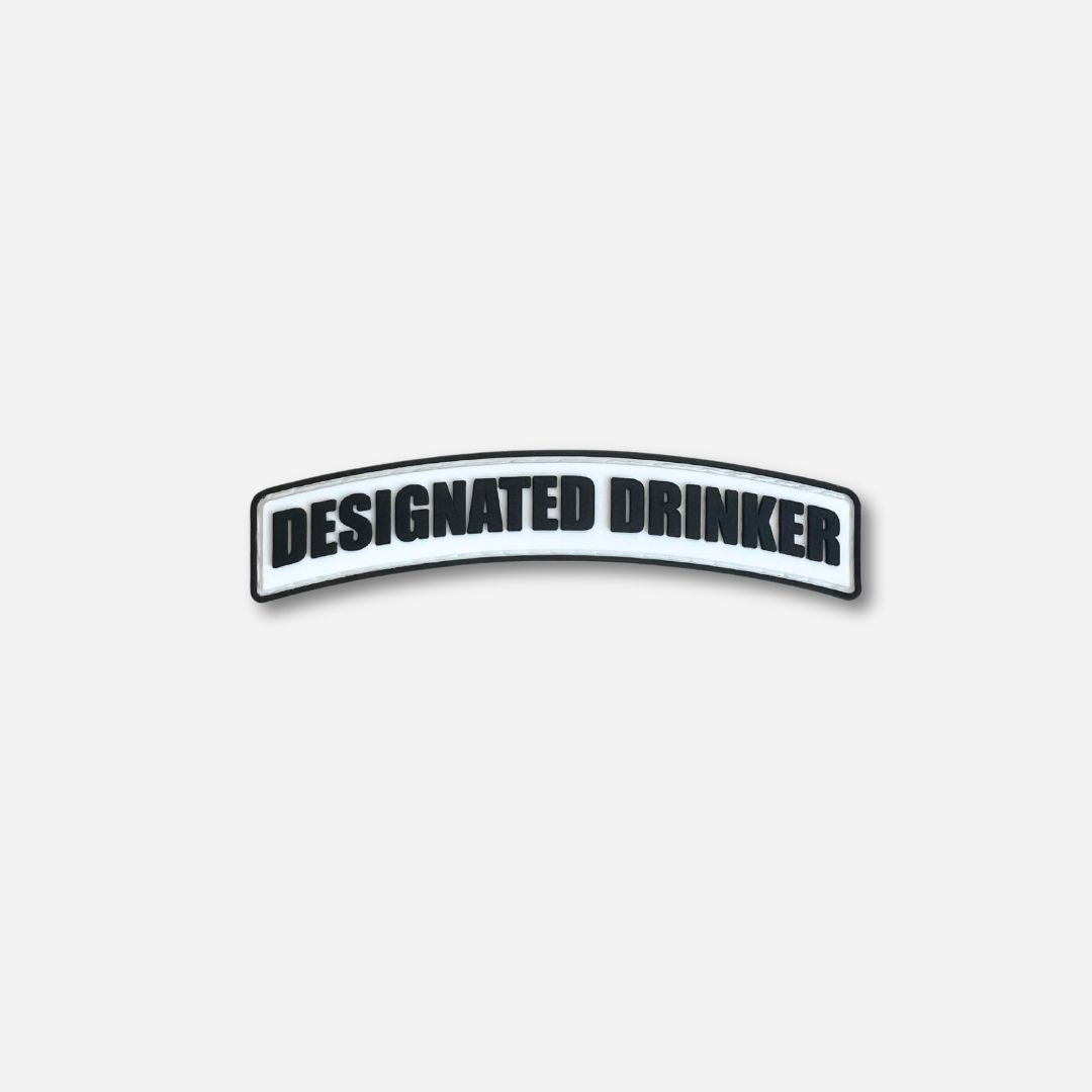 Velcro patch featuring the text &quot;DESIGNATED DRINKER&quot; in bold black letters on a white background.