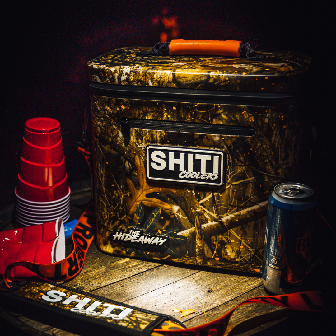 Realtree Soft Cooler by SHITI Coolers, designed for 12 cans, featuring a camouflage pattern and sturdy handles.