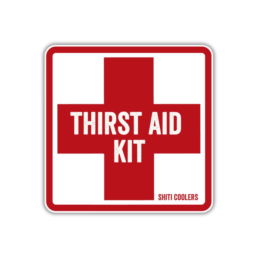 Red and white sticker featuring a cross design with the text &quot;THIRST AID KIT&quot; and &quot;SHITI COOLERS&quot; below.
