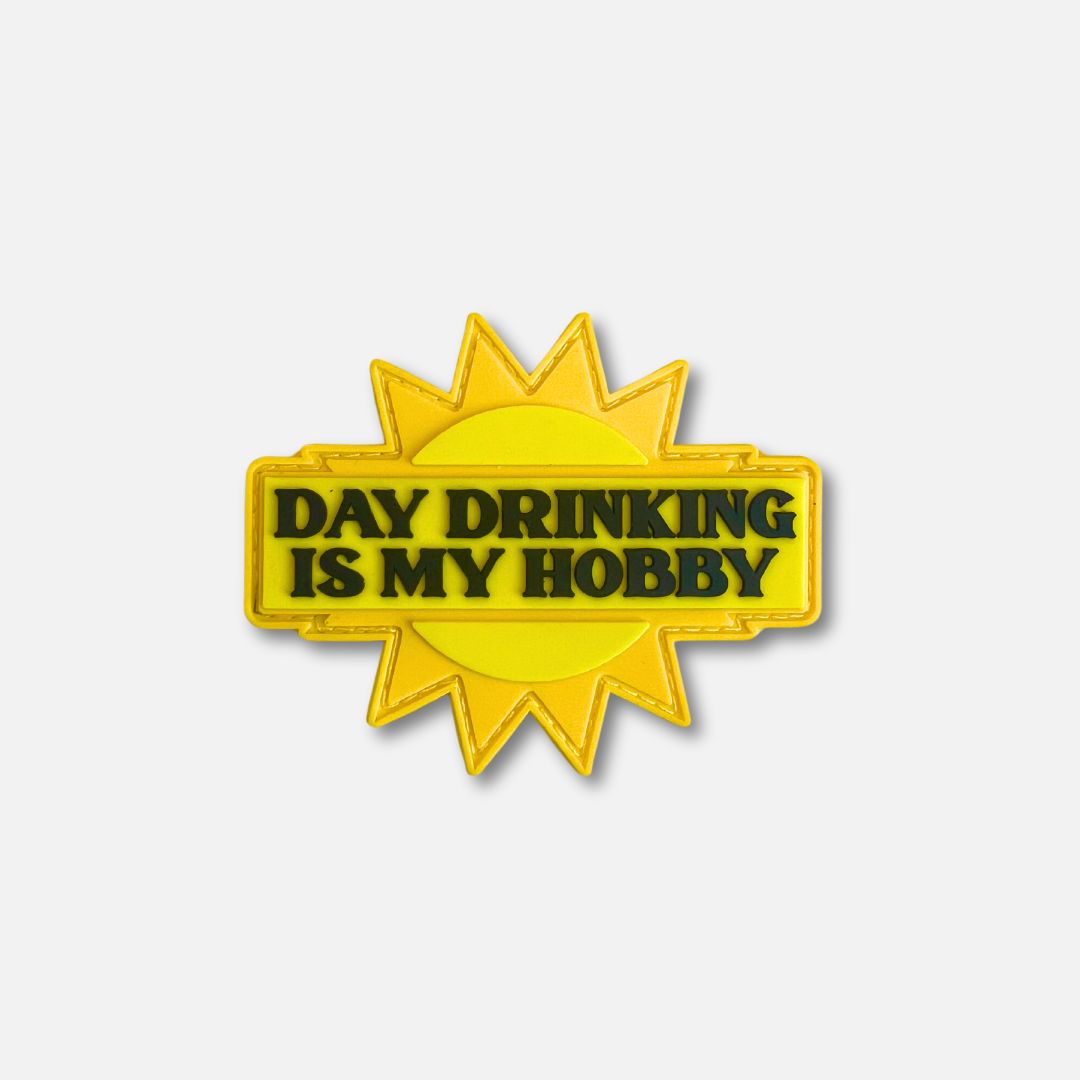 Bright yellow Velcro patch featuring the text "Day Drinking Is My Hobby" with a sunburst design.
