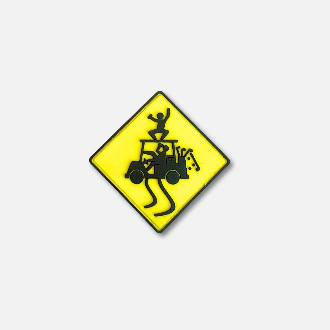 Yellow diamond-shaped Velcro patch featuring a cartoon figure riding on a golf cart with a playful design.