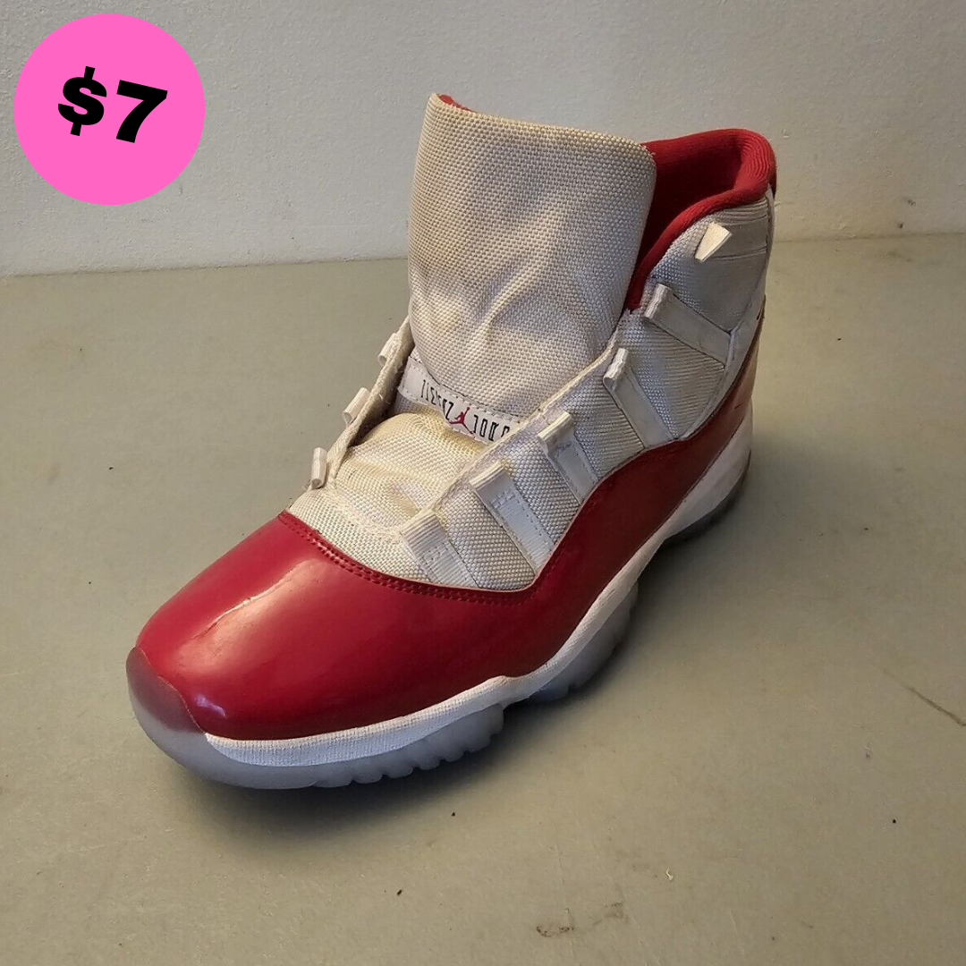 Left shoe featuring a red and white design with a high-top silhouette, priced at seven dollars.