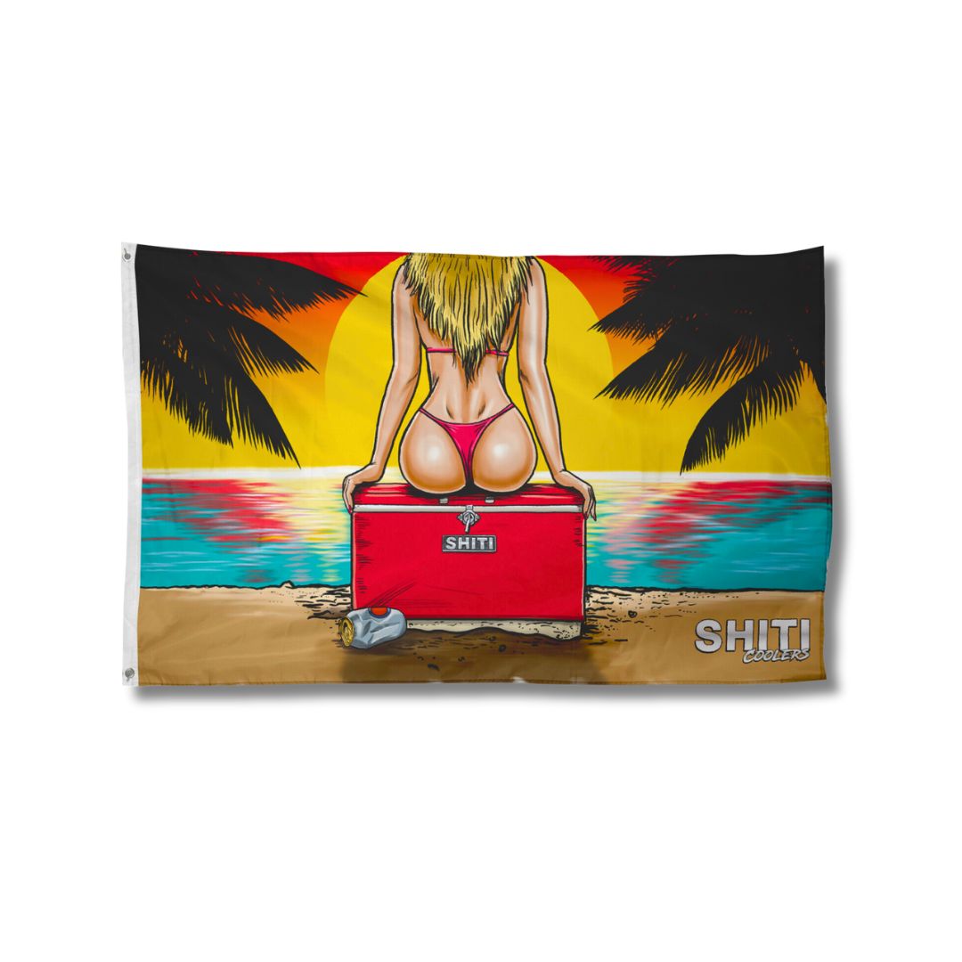 Colorful beach flag featuring a sunset, palm trees, and a figure in a bikini sitting on a cooler by the water.