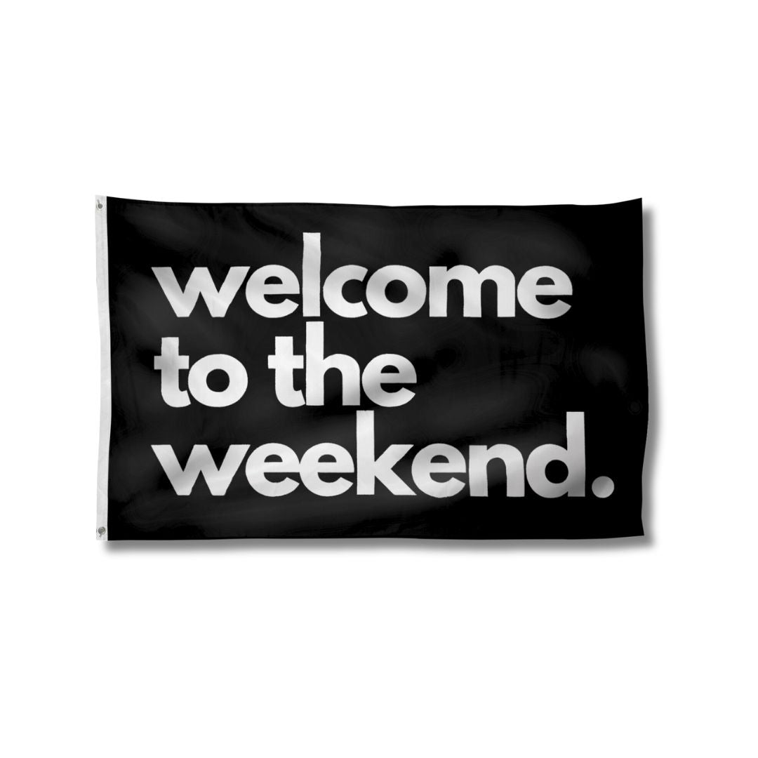 Black flag featuring bold white text that reads &quot;welcome to the weekend&quot; in a modern font.