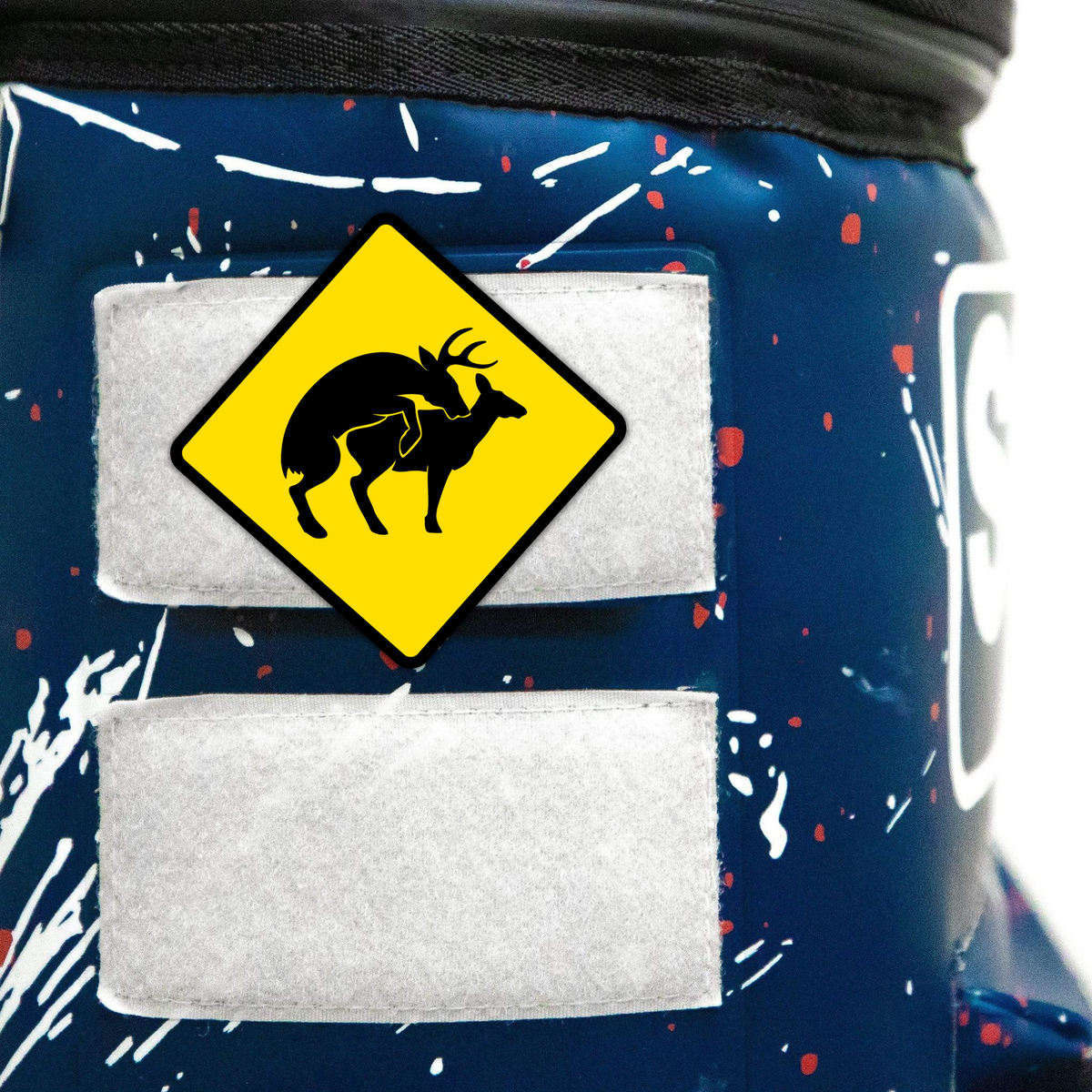 Yellow deer warning patch on a cooler, featuring a silhouette of a deer with antlers, attached with Velcro.